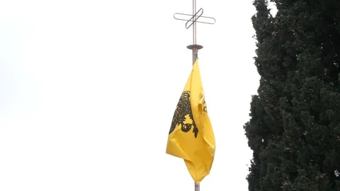 Two headed eagle Greek orthodox church emblem flag blowing in breeze Stock Footage 126840531