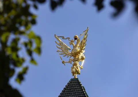 Two-headed Russian eagle as  symbol of statehood against  blue sky. Stock Photos