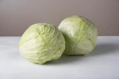 Two heads of white cabbage lie on the surface Stock Photos
