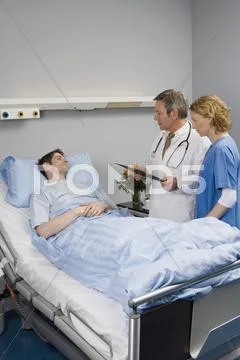 Two Healthcare Workers Speaking To A Patient