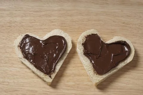 Two heart shaped bread slices with chocolate spread as Valentines day concept Stock Photos