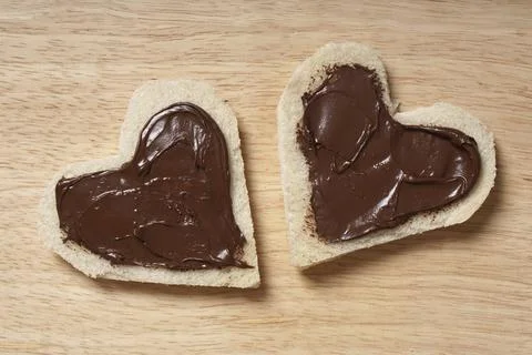 Two heart shaped bread slices with chocolate spread for Valentine's day Stock Photos