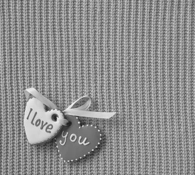 Two heart-shaped cookie making the I love you inscription on a red background Foto stock