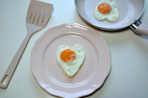 Two heart shaped eggs Stock Photos