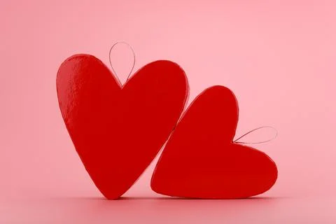 Two heart shaped glossy gift boxes on bright pink background. Concept of St Stock Photos