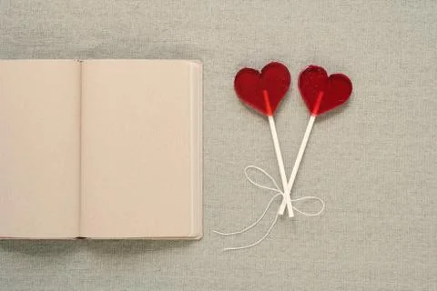 Two heart-shaped lollipops and an old diary Stock Photos