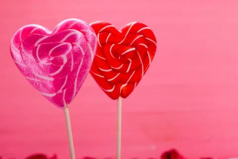 Two heart shaped lollipops. Red hearts. Love concept. Valentines day. Stock Photos