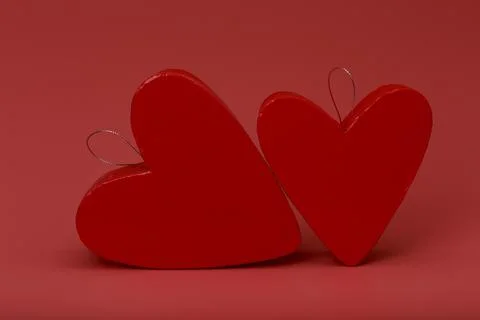 Two heart shaped red gift boxes on dark pink background. Concept of St Stock Photos