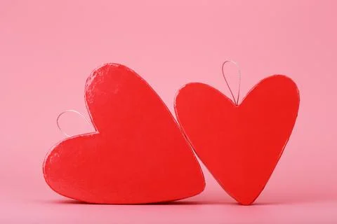 Two heart shaped red gift boxes on pink background. Concept of St. Valentine's Stock Photos