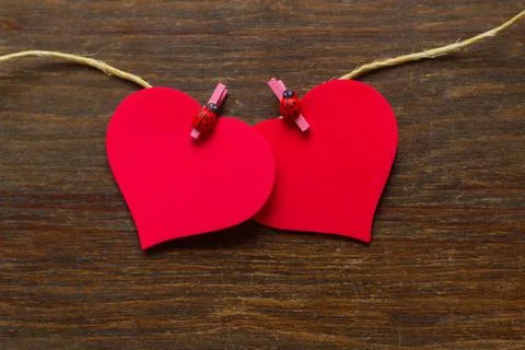 Two hearts attached to a rustic thread -  ladybirds Stock Photos