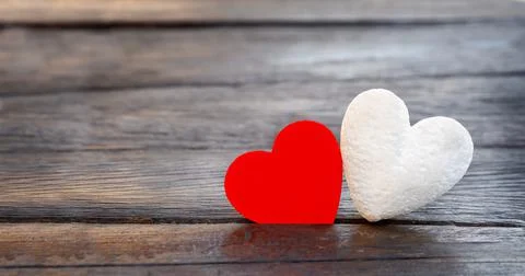 Two hearts on a dark background. Stock Photos