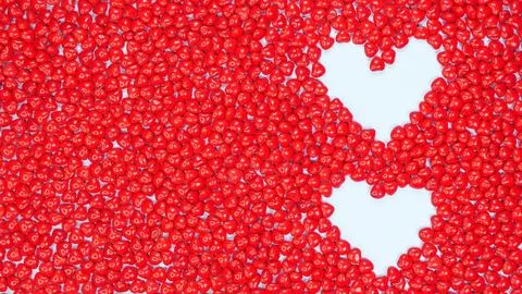 Two hearts lined with candy hearts on light blue background. Pink, white, red Stock Photos