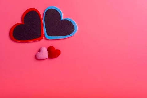 Two hearts on a pink background in the upper left corner and two small hearts Stock-Fotos