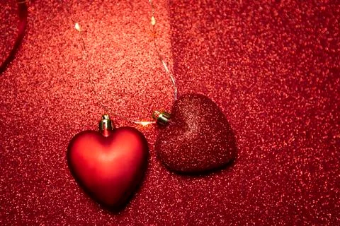 Two hearts on a red glittering background. Valentine's Day Stock Photos