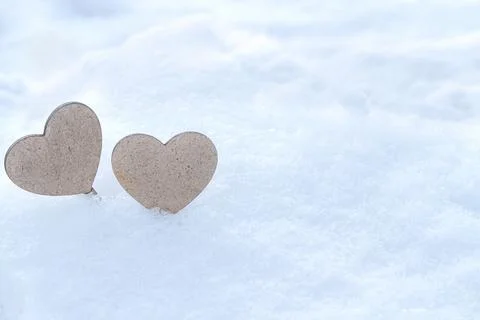 Two hearts on snow Stock Photos