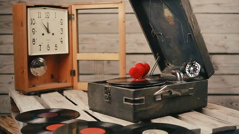 Two hearts spinning on vinyl record on a vintage gramophone Stock Footage 83680918