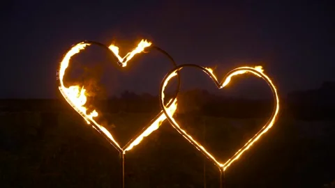 Two hearts standing side by side are burning under the open sky. Stock Footage 248144150