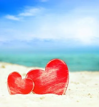 Two hearts on the summer beach Stock Photos