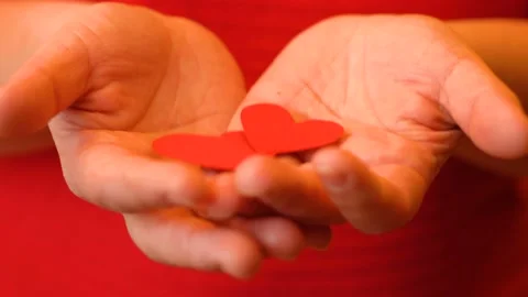 Two hearts in women's palms 4K Stock Footage 102440134