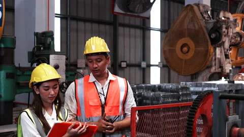 Two heavy industrial engineers check together in a steel factory. Video stock 173381091