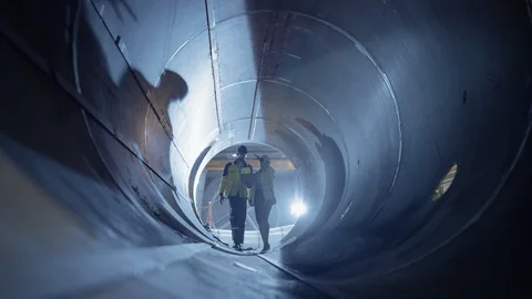 Two Heavy Industry Engineers Walking Inside Pipe, Use Laptop, Have Discussion 스톡 동영상 114814049