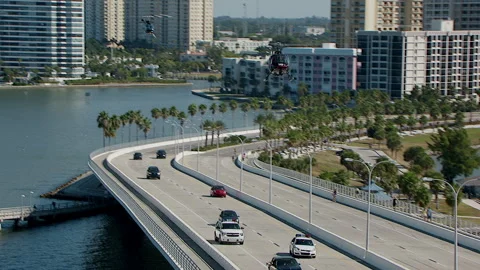 Two helicopters fly low over police chase on Florida bridge 動画素材 136200569
