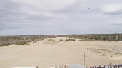 Two helicopters fly over the firing field Stock Footage 76838355