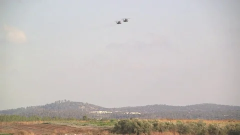 Two helicopters flying high over a village Video stock 76917302