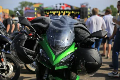 Two helmets hanging on a motorcycle Stock Photos