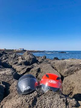 Two helmets on the rocks in island Stock Photos