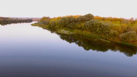 Two herons fly over the water Stock Footage 128658683