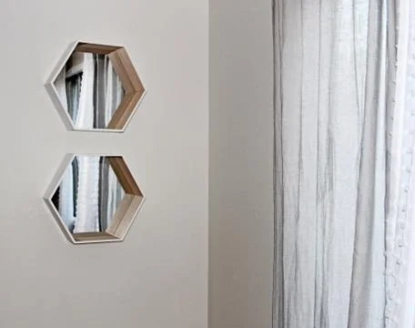 Two hexagonal mirrors on wall Stock Photos