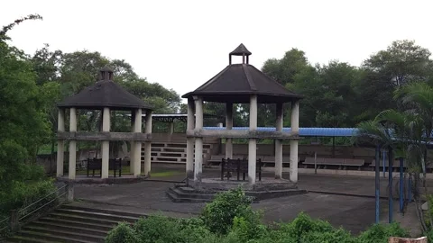 Two hexagonal stone gazebos inside a Hindu cremation ground standing empty durin Stock-Footage 342477404