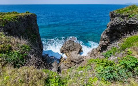 Two high cliffs above big wave Stock Photos