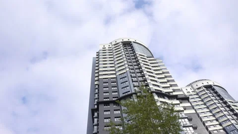 Two high-rise buildings in the cloudy sky in 4K Video stock 129824563