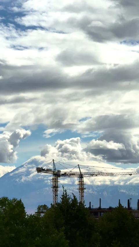 Two high-rise construction cranes on the construction of two skyscrapers against Stock Footage 320114857