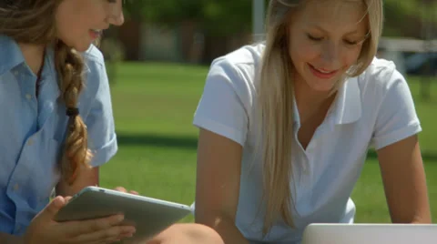 Two High School Girls Use A Tablet And Laptop Video stock 33190639