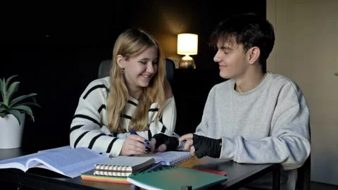 Two high school students, a boy and a girl, prepare for college lectures Stock Footage 237693550