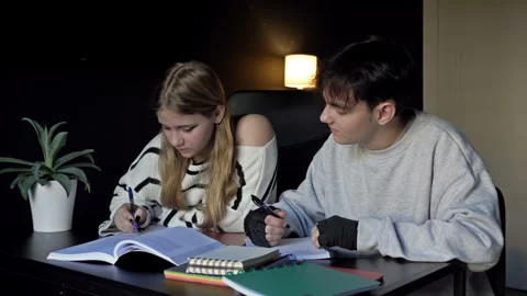 Two high school students, a boy and a girl, are getting ready for college Stock Footage 245973264