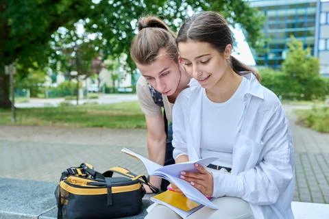 Two high school students guy and girl outdoor, school building background Fotos de archivo