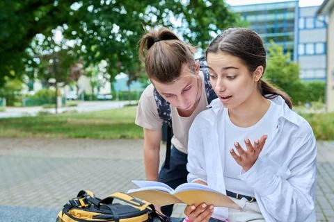 Two high school students guy and girl outdoor, school building background Fotos de archivo