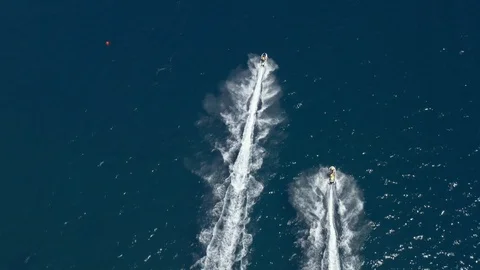 Two high-speed jets skies riding people resting aerial view of in sea resort Stock Footage 119233704
