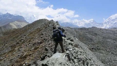 Two hiker men walking on the mountain path Stock Footage 77450483