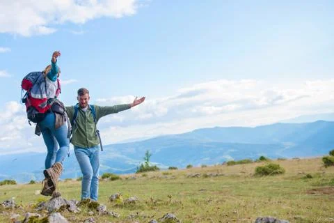 Two hikers with backpack standing on top of a mountain and look Foto stock