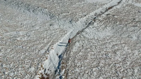 Two hikers climbing up on the winter mountain Stock Footage 99389078