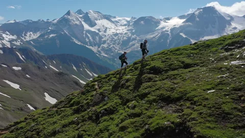 Two hikers (a couple) walking up a mountain in Austria in summer Stock Footage 150423637