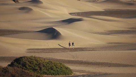 Two Hikers Crossing the Maspalomas Dunes, Gran Canaria Stock Footage 344480242