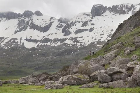 Two hikers exploring pyrenees mountains with snow Stock Photos