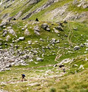 Two Hikers Follow a Path Stock Photos