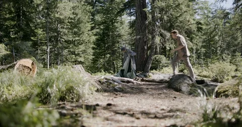 Two hikers installing a tent in the forest Stock Footage 145273340